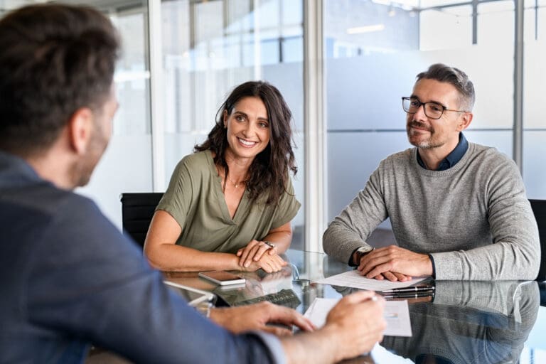 A couple meeting with a real estate agent.